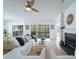 Sun-filled living room with a cozy fireplace and views of the outdoor deck at 2128 Baldwin Park Dr, Mount Pleasant, SC 29466