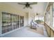 A bright screened-in porch has comfortable seating and access to the back yard at 2128 Baldwin Park Dr, Mount Pleasant, SC 29466