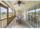 Screened-in porch with comfortable seating overlooking a peaceful backyard and water view at 2128 Baldwin Park Dr, Mount Pleasant, SC 29466