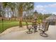 A backyard patio with a dining set, grill, landscaping, privacy fence, and palm tree at 222 Medford Dr, Summerville, SC 29485