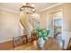 A beautifully staged dining room with a chandelier, a wooden table, and views to the staircase at 222 Medford Dr, Summerville, SC 29485