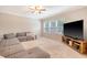 Comfortable living room with a large sectional sofa, a large screen tv, and a ceiling fan at 222 Medford Dr, Summerville, SC 29485