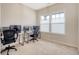 A home office with large windows and two desk spaces set up with multiple monitors at 222 Medford Dr, Summerville, SC 29485
