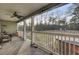 Covered back porch with furniture overlooks a large backyard at 223 Fox Field Rd, Walterboro, SC 29488