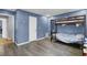 Bedroom featuring a bunk bed and window with blue walls and laminate flooring at 223 Fox Field Rd, Walterboro, SC 29488