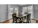 Bright dining room with wood table, six chairs, and glass doors leading to the outdoor deck at 223 Fox Field Rd, Walterboro, SC 29488