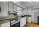 Traditional kitchen featuring white cabinets, stainless steel appliances, and a wood countertop at 223 Fox Field Rd, Walterboro, SC 29488