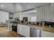 Well-equipped kitchen with a stainless steel dishwasher, oven and view to living area at 223 Fox Field Rd, Walterboro, SC 29488