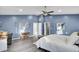 Large main bedroom featuring blue walls, wood-look flooring, and a ceiling fan at 223 Fox Field Rd, Walterboro, SC 29488