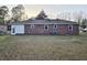Rear view of a brick home and spacious backyard at 228 Jean Wells Dr, Goose Creek, SC 29445