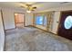 Bright living room featuring large windows, neutral carpet, and an open doorway to an adjoining room at 228 Jean Wells Dr, Goose Creek, SC 29445