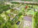 Aerial view of a wooded community with a mix of homes, green spaces and a winding creek at 2285 Cooper Store Rd, Moncks Corner, SC 29461
