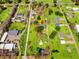 A high-angle aerial view shows a neighborhood dotted with houses, manicured green lawns, and shade trees at 2285 Cooper Store Rd, Moncks Corner, SC 29461