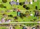 Bird's-eye view of the homes and expansive green lawns interspersed with trees, outbuildings, and vehicle parking at 2285 Cooper Store Rd, Moncks Corner, SC 29461