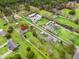 An aerial view of houses amidst lush greenery, highlighted by a red arrow indicating the property at 2285 Cooper Store Rd, Moncks Corner, SC 29461