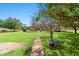 Spacious backyard with a wheelbarrow, mature trees and greenery, ideal for gardening and relaxation at 2285 Cooper Store Rd, Moncks Corner, SC 29461