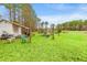 Backyard featuring outbuilding and lush green space with mature trees, offering privacy and room to roam at 2285 Cooper Store Rd, Moncks Corner, SC 29461