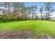 Large grassy backyard surrounded by mature trees offering shade and privacy at 2285 Cooper Store Rd, Moncks Corner, SC 29461
