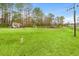 Expansive, lush backyard with a quaint shed and recreational area, perfect for outdoor activities at 2285 Cooper Store Rd, Moncks Corner, SC 29461