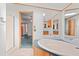 Bathroom featuring a bathtub, shower, and a spacious mirror above the countertop with cabinets at 2285 Cooper Store Rd, Moncks Corner, SC 29461