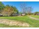 Charming home with a well-maintained lawn, framed by mature trees and clear blue skies at 2285 Cooper Store Rd, Moncks Corner, SC 29461