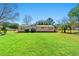 Charming single-story home with well-kept lawn, trees and a welcoming entrance on a sunny day at 2285 Cooper Store Rd, Moncks Corner, SC 29461