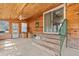 Sunroom with natural wood ceiling and brick steps leading outside through a sliding door at 2285 Cooper Store Rd, Moncks Corner, SC 29461