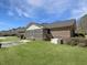 View of the backyard, showing the screened porch and well-maintained green grass lawn at 243 Country Club Blvd, Saint George, SC 29477