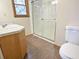 Bathroom with walk-in shower with glass enclosure, vanity, and toilet at 243 Country Club Blvd, Saint George, SC 29477