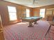 Recreation room with a pool table, wood-paneled walls, and bright windows at 243 Country Club Blvd, Saint George, SC 29477