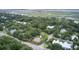 Aerial view of a home in a lush, wooded neighborhood with marsh in the distance at 2530 Jasper Blvd, Sullivans Island, SC 29482