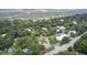 Scenic aerial view of a neighborhood with lush trees and marsh, showcasing the property's landscape at 2530 Jasper Blvd, Sullivans Island, SC 29482