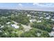 Expansive aerial view of a lush community near the coast, featuring mature trees and diverse home styles at 2530 Jasper Blvd, Sullivans Island, SC 29482