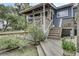 Inviting back porch with wooden deck and steps, leading to a screened-in sitting area at 2530 Jasper Blvd, Sullivans Island, SC 29482