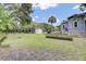 Spacious backyard with a shed, covered storage, and ample green space, surrounded by mature trees at 2530 Jasper Blvd, Sullivans Island, SC 29482