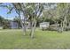 Large backyard with a fence and trees, showcasing a shed and a chicken coop at 2530 Jasper Blvd, Sullivans Island, SC 29482
