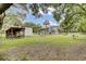 Expansive backyard featuring a shed, wooden deck, and lush green space, perfect for outdoor living at 2530 Jasper Blvd, Sullivans Island, SC 29482