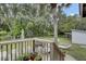 Expansive backyard view from the wooden deck, showcasing the lush greenery and fenced perimeter at 2530 Jasper Blvd, Sullivans Island, SC 29482