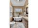 Elegant bathroom featuring a classic clawfoot tub and a vanity with a marble countertop at 2530 Jasper Blvd, Sullivans Island, SC 29482