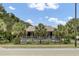 Charming home with a wide front porch lined with palm trees, creating a welcoming curb appeal at 2530 Jasper Blvd, Sullivans Island, SC 29482