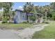 Coastal home features a screened porch, palm trees, and a well-maintained landscape at 2530 Jasper Blvd, Sullivans Island, SC 29482