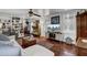 Bright living room featuring a large sectional, hardwood floors, and custom built-in shelving at 2530 Jasper Blvd, Sullivans Island, SC 29482