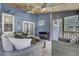 Comfortable screened porch with wicker furniture, ceiling fans, and serene blue accents at 2530 Jasper Blvd, Sullivans Island, SC 29482