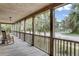 Inviting porch with wooden flooring, railing, and comfortable rocking chairs with views of the street at 2530 Jasper Blvd, Sullivans Island, SC 29482