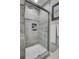 Bathroom shower with gray textured wall, showerhead, and built in alcove shelving at 2530 Jasper Blvd, Sullivans Island, SC 29482