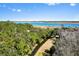 An aerial view captures a waterway, some houses, and several piers and docks on a sunny day at 2725 Starfish Dr, Johns Island, SC 29455