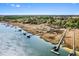 Expansive aerial shot of waterfront homes with docks and marshland under a clear sky at 2725 Starfish Dr, Johns Island, SC 29455