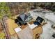 An aerial shot focuses on the house and detached garage, highlighting the landscaping and layout of the property at 2725 Starfish Dr, Johns Island, SC 29455