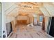 Unfinished attic space with exposed rafters, insulation, and plywood flooring at 2725 Starfish Dr, Johns Island, SC 29455