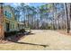 Expansive backyard featuring a well-manicured lawn, complemented by towering trees, and landscaping at 2725 Starfish Dr, Johns Island, SC 29455